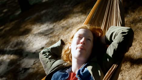 Woman-relaxing-on-a-hammock-in-the-forest-4k