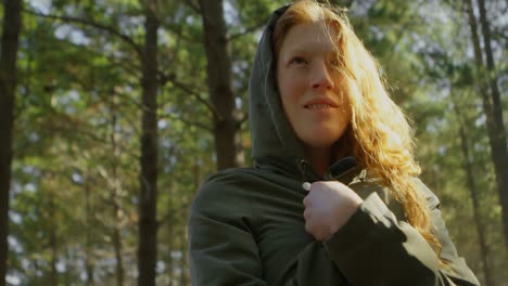 Woman-in-hoodie-standing-in-the-forest-4k
