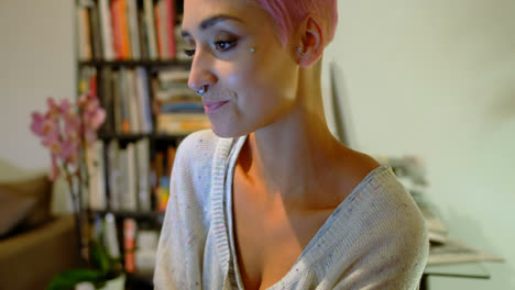 Pink-hair-woman-having-coffee-at-home-4k