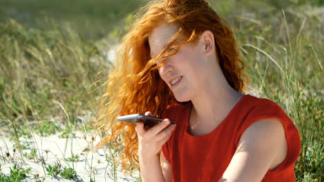 Woman-talking-on-mobile-phone-in-the-beach-4k