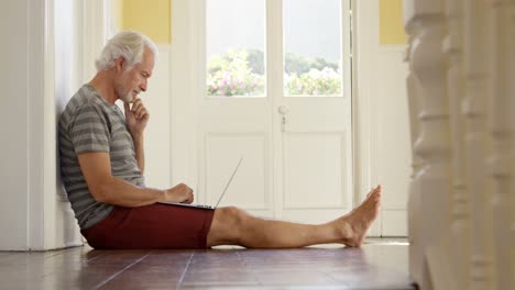 Senior-man-using-laptop-at-home-4k