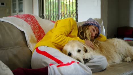 Woman-relaxing-on-sofa-with-her-dog-4k