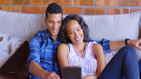 Couple-using-digital-tablet-on-sofa-4k