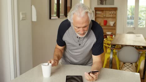 Senior-man-using-mobile-phone-on-table-4k