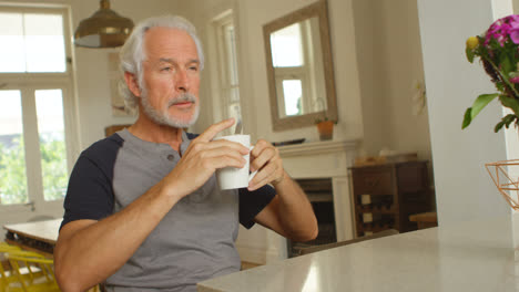 Senior-man-having-coffee-on-table-4k
