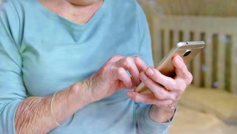 Senior-woman-using-mobile-phone-at-home-4k