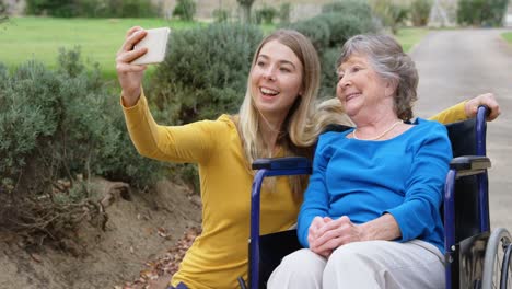 Senior-woman-and-young-girl-taking-selfie-4k