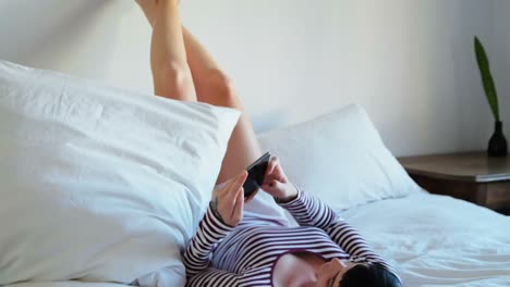 Woman-using-mobile-phone-in-bedroom-4k