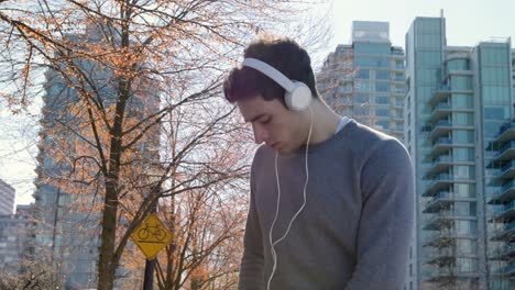 Man-listening-music-while-jogging-on-street-4k