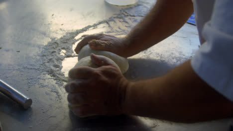 Male-chef-kneading-flour-in-kitchen-4k