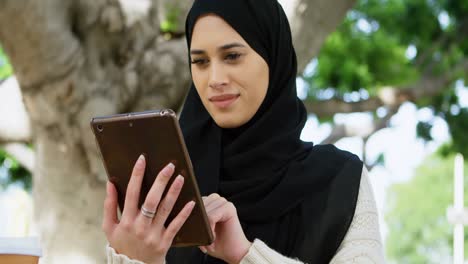 Woman-in-hijab-using-digital-tablet-4k