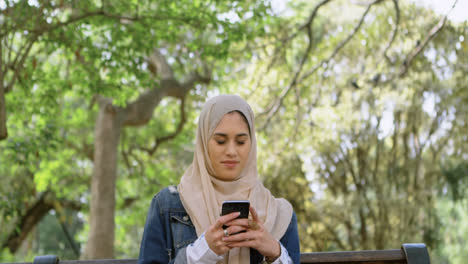 Woman-in-hijab-using-mobile-phone-4k