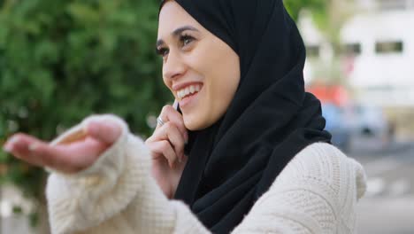 Woman-in-hijab-talking-on-the-phone-4k