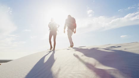 Couple-with-back-pack-walking-in-the-desert-4k