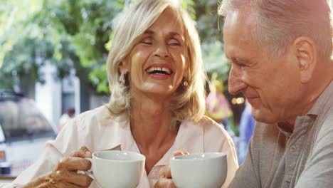 Senior-couple-having-coffee-in-cafe-4k