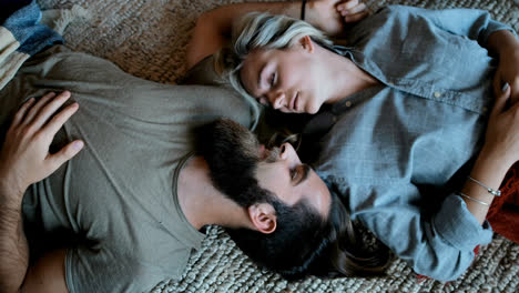 Couple-lying-upside-down-in-living-room-4k