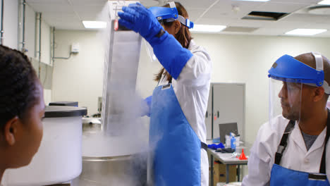 Scientist-putting-vertical-freezer-rack-in-freezer-4k
