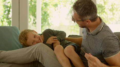 Father-and-son-having-fun-on-sofa-4k
