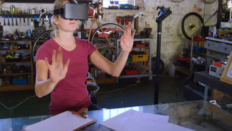 Woman-using-virtual-reality-headset-at-workshop-4k
