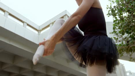 Female-ballet-dancer-stretching-before-dancing-4k