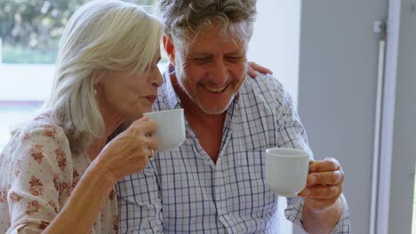 Senior-couple-having-coffee-in-porch-4k