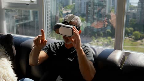Man-using-virtual-reality-headset-on-sofa-4k