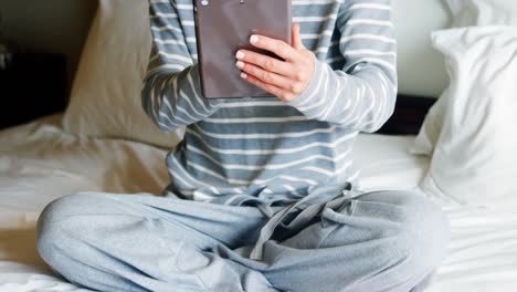 Woman-using-digital-tablet-on-bed-4k