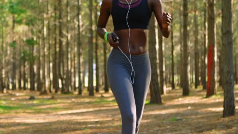 Woman-jogging-in-the-forest-4k
