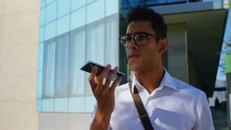 Man-talking-on-mobile-phone-while-walking-on-street-4k