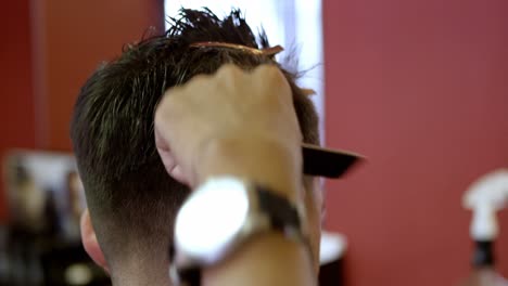 Man-getting-his-hair-trimmed-with-scissor-4k