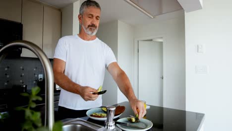Man-preparing-breakfast-in-kitchen-4k