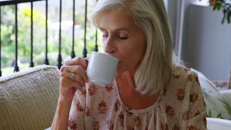 Senior-woman-having-coffee-in-porch-4k