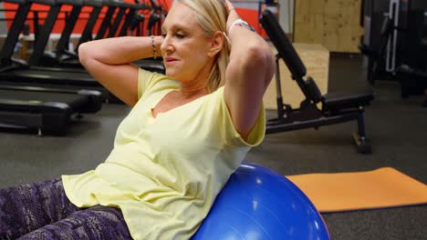 Senior-woman-doing-abs-workout-with-exercise-ball-4k