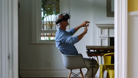Senior-man-using-virtual-reality-headset-at-home-4k