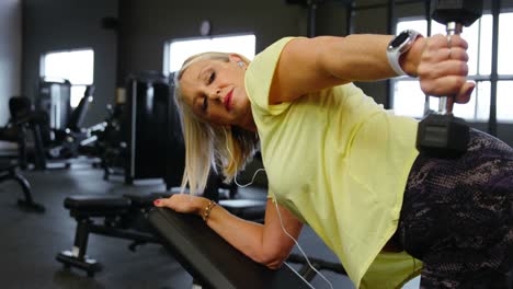Senior-woman-doing-dumbbell-row-exercise-in-fitness-studio-4k