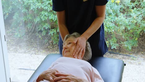 Physiotherapist-giving-head-massage-to-senior-woman-4k
