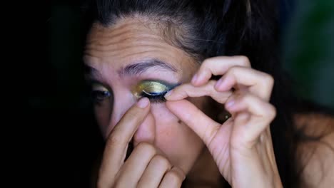Female-video-blogger-applying-eyelash-at-home-4k