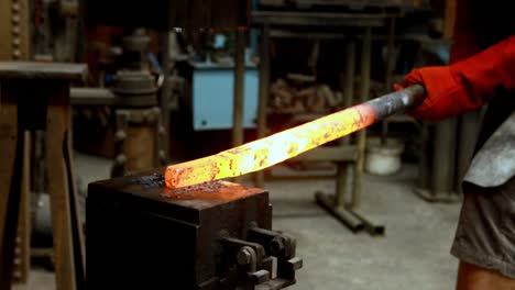 Blacksmith-shaping-hot-metal-rod-in-machine-4k