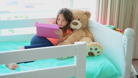 Girl-using-digital-tablet-on-bed-in-bedroom-4k