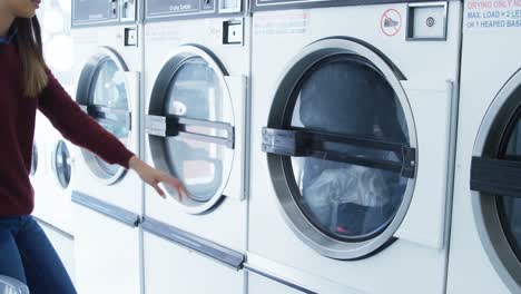Woman-removing-clothes-from-washing-machine-4k
