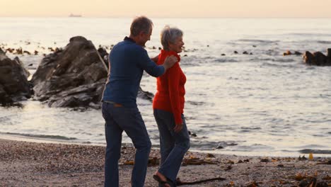 Senior-couple-walking-on-beach-4k