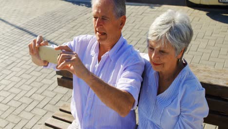Senior-couple-taking-pictures-at-promenade-4k