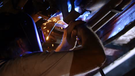 Male-mechanic-using-flaming-torch-4k