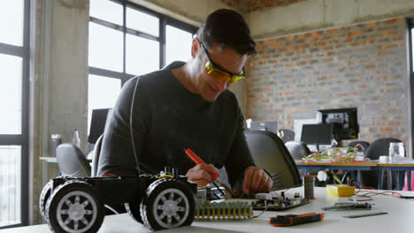 Male-electrical-engineer-soldering-a-circuit-board-4k