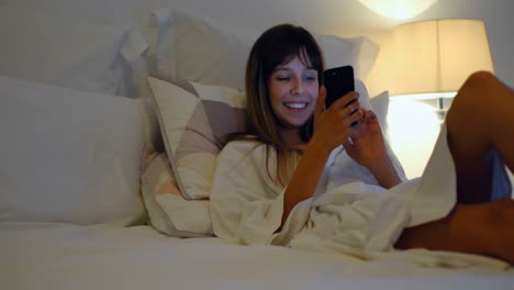 Woman-using-mobile-on-bed-in-bedroom-at-home-4k