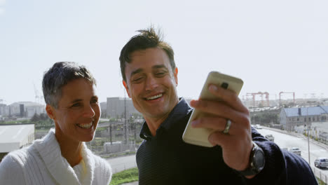 Executives-taking-selfie-on-terrace-4k