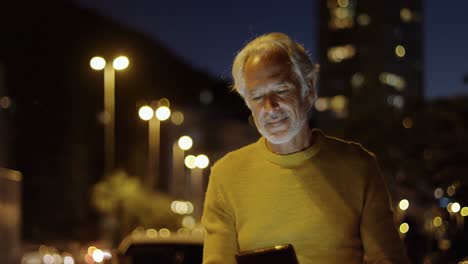 Senior-man-using-digital-tablet-near-street-4k