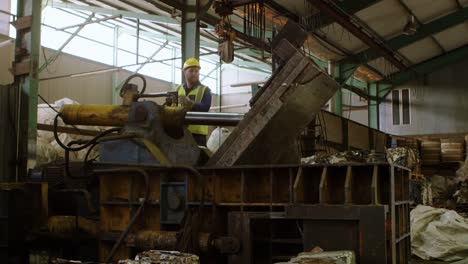 Male-worker-working-on-machine-in-warehouse-4k