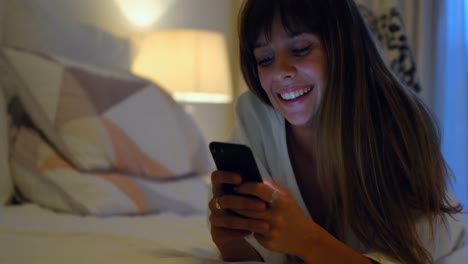 Woman-using-mobile-on-bed-in-bedroom-at-home-4k