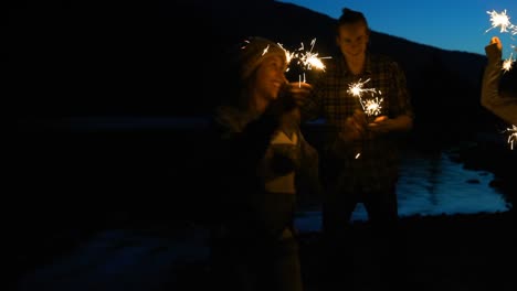 Group-of-hikers-dancing-with-sparklers-4k